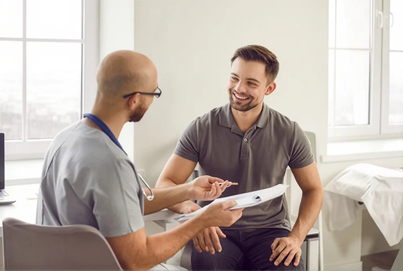A clinician going through a patient's recovery plan with them